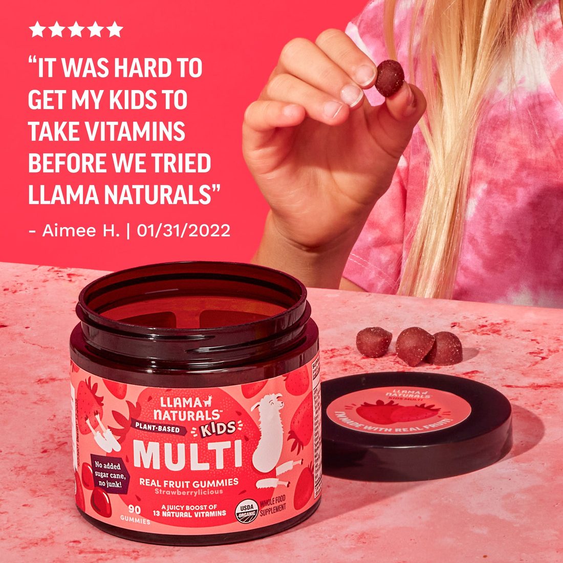 Child&rsquo;s hand reaching for a gummy from an open Llama Naturals Kids Multi jar